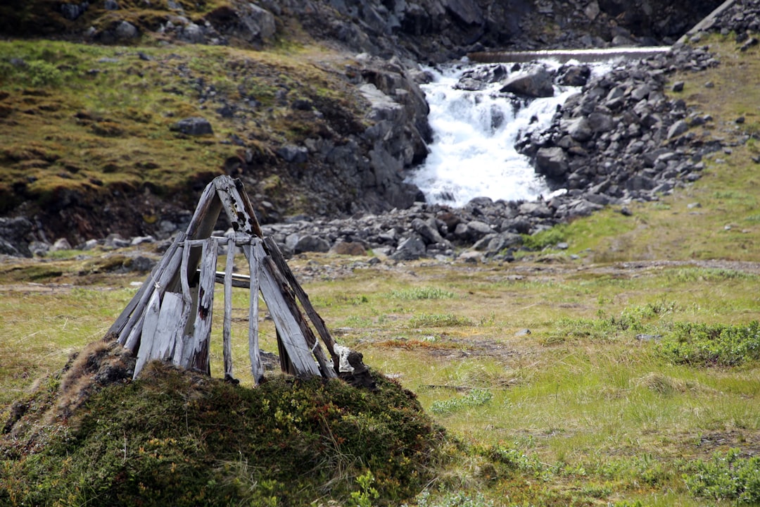 Sami hut skeleton near a falling river.